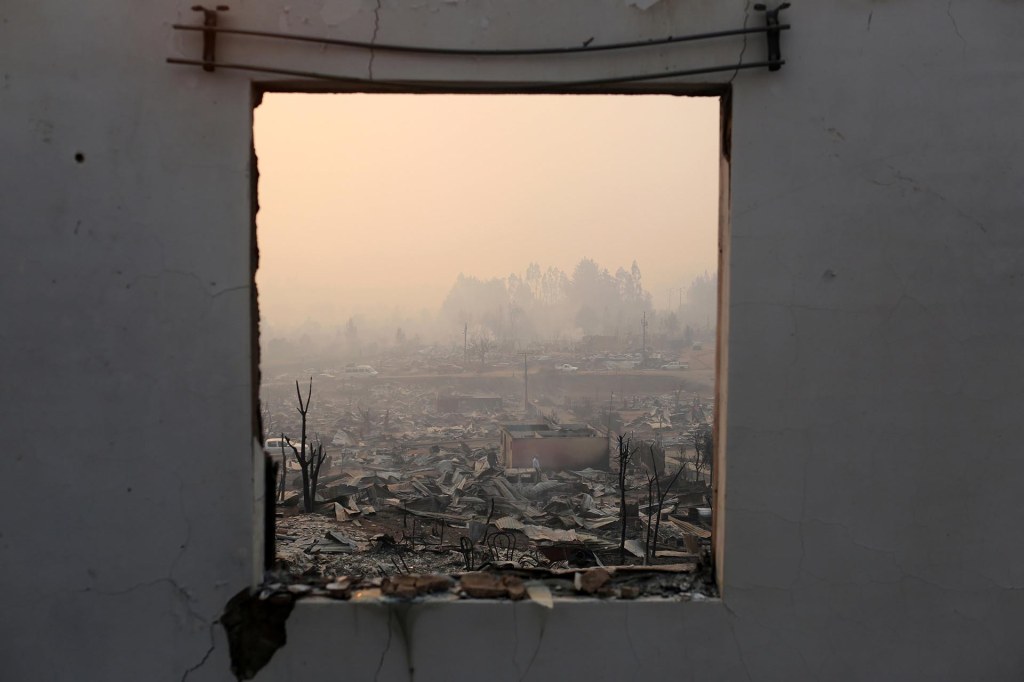 The remains of burnt houses are seen as the worst wildfires in Chile's modern history ravage wide swaths of the country's central-south regions, in Santa Olga